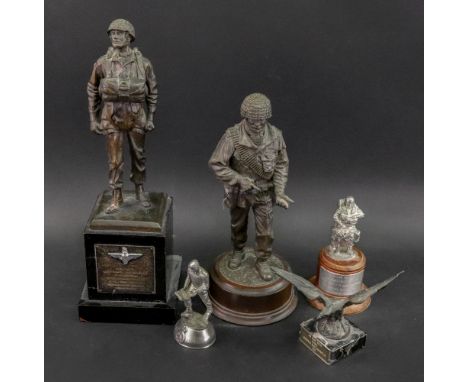 A resin figure of an airman, standing on an ebonised wooden plinth applied with a plaque inscribed 'Presented to Lieut. Colon