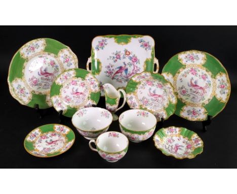 A Minton fifty two piece tea service, painted to the centres with a pheasant amongst flowering branches reserved against a gr