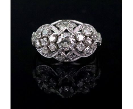 A diamond dress ring, the pierced domed setting with central modern cut stone of approximately 0.2ct, flanked by seven stone 