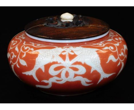 A Japanese porcelain koro, with original wood cover, decorated in coral and pale yellow enamel, with pairs of carp, signed in