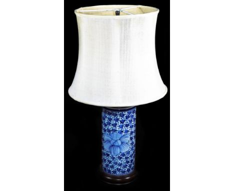 A Chinese porcelain table lamp, of cylindrical form with wooden mounts decorated with flower heads and dots, with modern elec