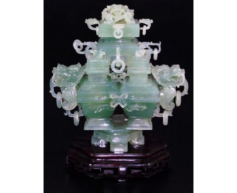 An elaborate Chinese green quartz quadruple vase, with four compartments and dragon head handles, with complex carved cover w