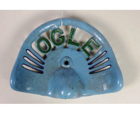 An "Ogle" square point Tractor Seat, painted sky blue with green lettering, GB 46.6 Rate 6, FR 775 Rate 6. (1)