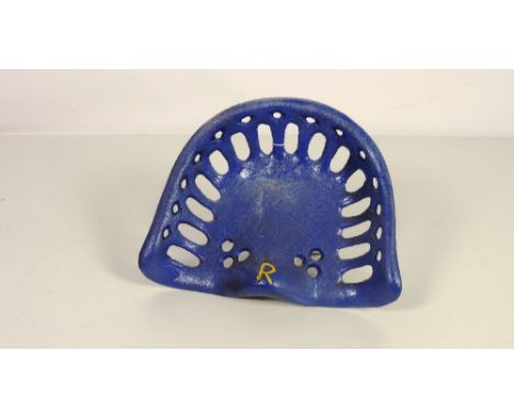 A "Nicholson - R. mark (on hump) Tractor Seat, painted blue and yellow, G.B. 43.5, Rate 9. (1)
