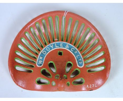 A "M. Doyle & Co. Ltd" small banana Tractor Seat, painted peach, green, blue and white, (cast no: A27L), G.B. P. 21 3/6, type