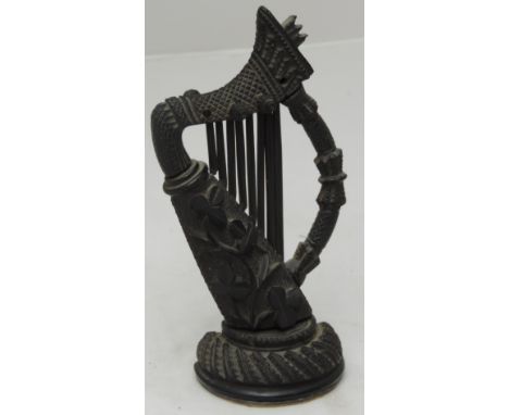 A good quality 19th Century Irish carved bog oak Harp, in the Celtic style, and with shamrocks on circular base, 7" (18cms). 