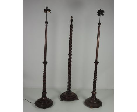 An almost matching pair of bobbin turned oak Standard Lamps, and a similar Standard Lamp with barley twist pillar. (3)

Prove