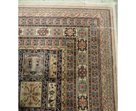 An attractive large fawn ground Carpet, with multiple borders and centre with multiple small decorated squares, approx. 462cm