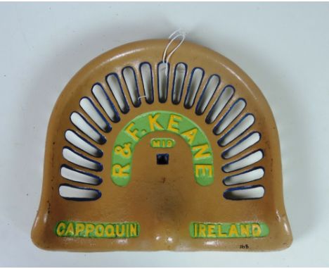 A "R. & F. Keane, Cappoquin, Ireland (M. 19)" Tractor Seat, painted cream, with yellow and green text G.B., 35/5, Rate 9. (1)