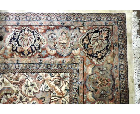 A good silk Carpet, with large decorated border, center cream ground field decorated with flowers etc., approx. 391cms x 277c