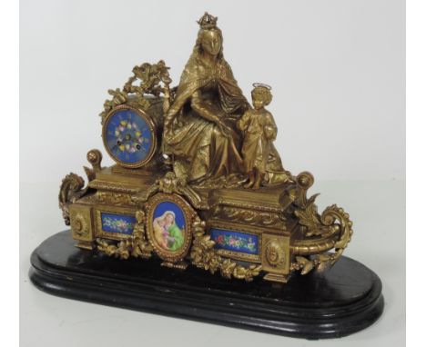 A large Victorian gilt metal and ormolu Mantel Clock, surmounted with Virgin & Child Jesus,with hand painted porcelain dial a