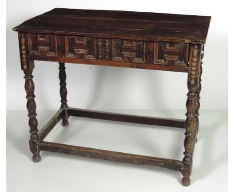 An early English oak Side Table, with a three plank top over a frieze drawer with panelled front, on ring turned legs united 