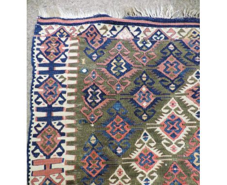 A handwoven Kurdish semi-antique Van Kilim, the small double hooked motifs forming two large diamonds, side border of similar