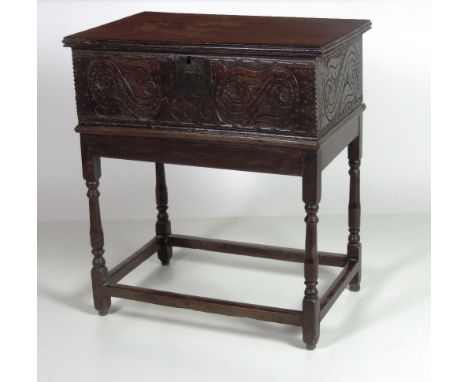 An early 17th Century carved oak Bible Box, with plank top carved front and sides, and dated 1606 or 1686, the interior lined
