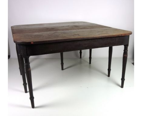 An early 19th Century mahogany Economy Table, in two parts, one part with falling leaf, on eight ring turned legs, approx. 15