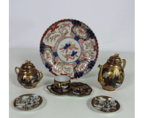 An unusual part Japanese Tea Service, with teapot, sugar bowl, and cream jug, all with lids, cups, saucers etc., and an Imari