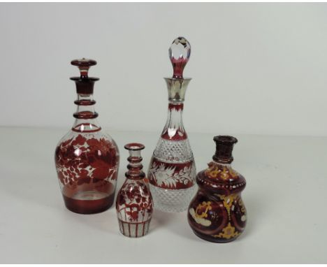 A large 19th Century ruby decorated glass Decanter and stopper, 33cms (13") high; a smaller similar ditto (lacking stopper), 