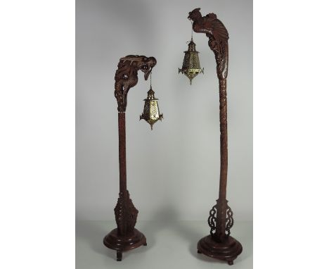 A tall Oriental carved wooden Standard Lantern Holder, carved with a perched peacock, and with engraved and pierced brass lan