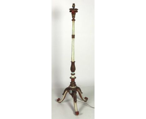 A carved wooden Lamp Standard, on tripod base, decorated in various colours with gilt highlighting. (1)