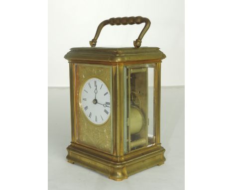 A good quality late 19th Century heavy brass Repeater Carriage Clock, possibly English, the engraved face decorated with scro