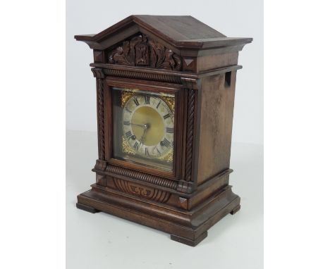 An Edwardian carved oak Cuckoo Clock, with brass and silvered dial, on a moulded base with square feet. (1)