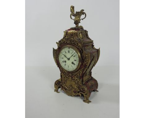 A good quality 19th Century French Louis XV style red boulle and ormolu mounted Mantle Clock, with urn shaped finial on top t