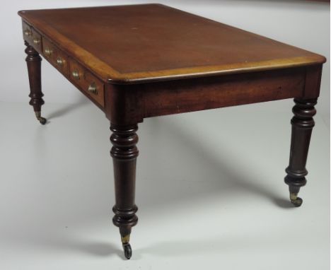 A large Victorian mahogany Partners Desk, the rectangular inset top over three large frieze drawers on ring turned legs, bras