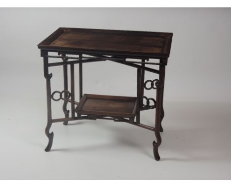 A heavy Oriental hardwood tray top Occasional Table, with fret carved rim, of rectangular shape with smaller matching underne