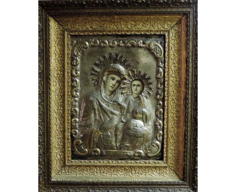 Late 19th Century Russian School

An antique silvered and gilt metal Icon, the panel embossed with Virgin & Child, and initia