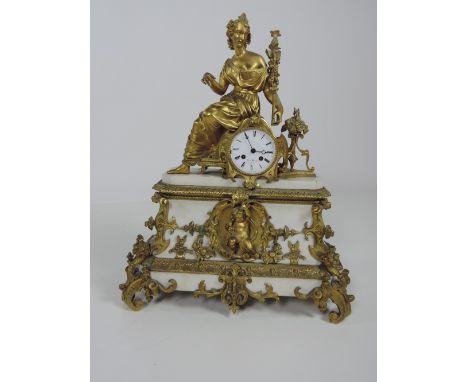 A large and ornate 19th Century French marble and ormolu Mantle Clock, with female figure surmounted, the circular enamel dia