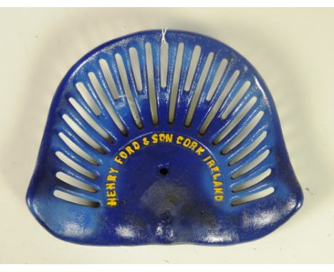 A "Henry Ford & Son, Cork, Ireland," Tractor Seat, painted royal blue and yellow text, * no reference, Rate 10. (1)