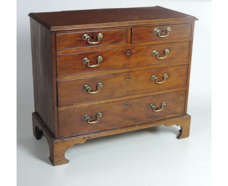 A good small early 19th Century mahogany Chest, the rectangular crossbanded top over two short and three long drawers, with o