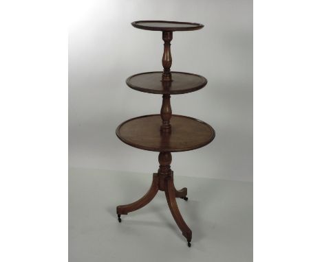 A 19th Century three tier mahogany Dumb Waiter, the three moulded circular shelves  supported by turned pillars, on an inlaid