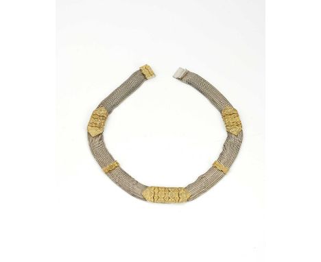 A Middle Eastern silver and parcel gilt choker necklace, nine chain mesh strands united by tooled gilt bars, engraved with bi