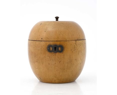 A George III turned fruitwood tea caddy, circa 1810, in the form of an apple, stalk finial, fretwork metal escutcheon, remnan