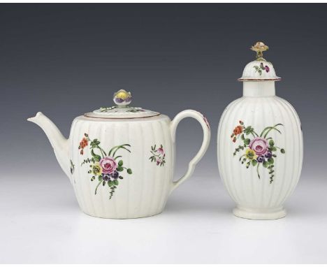A Worcester polychrome reeded teapot and a tea caddy, circa 1765, the barrel for pot with floral sprays, ogee handle, the can