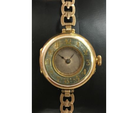 Rolex - A lady's 18ct gold wristwatch, the circular unsigned silvered dial with green/grey enamel chapter ring with white ena