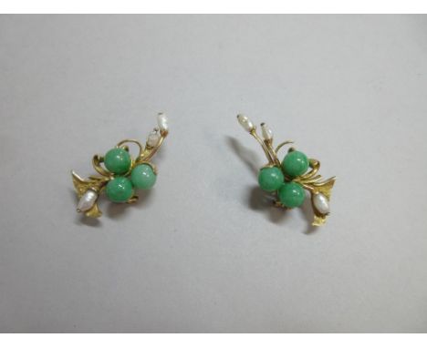 A pair of jade and freshwater pearl earrings, of asymmetric design, each set with three 9mm mottled mid green jade bead berri