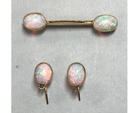 An opal brooch and earring suite, the brooch of dumbbell form with twin knife edge bars leading to a collet set oval cabochon