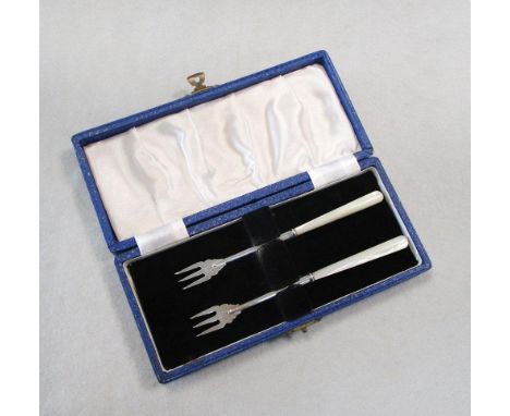 A pair of George V silver olive forks, by Adie & Lovekin, Chester 1913, with tubular slightly tapering mother of pearl handle