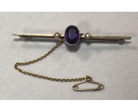 An amethyst and pearl bar brooch, with a central oval cut amethyst in a millegrain collet between two seed pearls similarly s