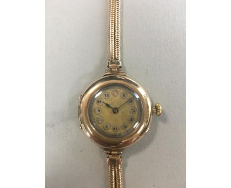 Rolex - A lady's 9ct gold wristwatch, the circular unsigned gold coloured engine turned dial with Arabic numerals within silv