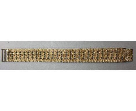 A flower pattern cuff bracelet, the uniform links designed as elongated flowerheads with a splay of leaves at either end, mas