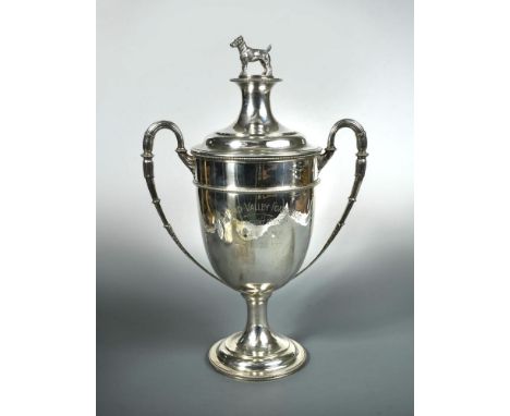 A Victorian silver two handled trophy cup and cover, by HC Freeman & Co, London 1900, of plain urn shaped form with beaded gi