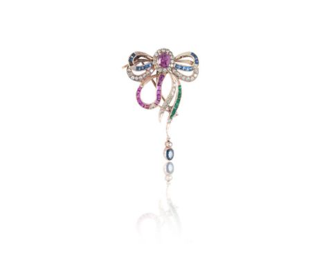 A diamond and gemset ribbon brooch / earpendant, of asymmetrical design with a 'knot' composed of an oval cut ruby surrounded