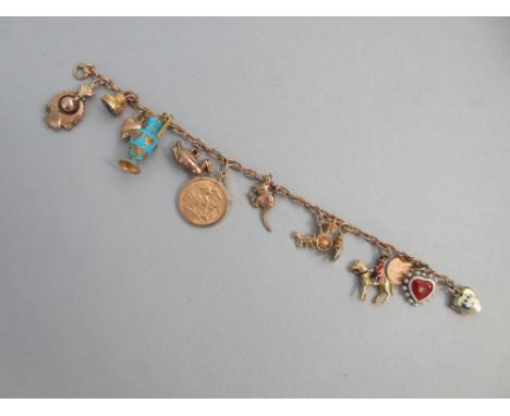 A charm bracelet with two antique enamelled heart lockets and a half sovereign amongst other charms, the filed trace link bra