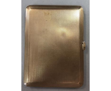 A 9ct gold pocket cigarette case by Mappin & Webb, bevel edged and engine turned all over with push in thumbpiece, fitted wit