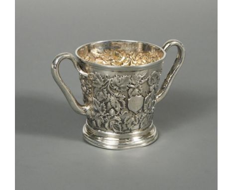 A Victorian silver two handled mug by John Samuel Hunt, London 1863, heavily embossed all over with vine leaf, grape and tend