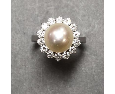 A South sea cultured pearl and diamond cluster ring, the 10mm pearl set above a petal edge border of uniform round brilliant 