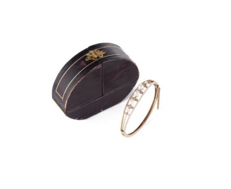 A cultured pearl and diamond hinged bangle, constructed of three knife-edge bars which flare at the front to hold a graduated